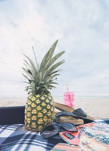 fruit pineapple beside black sunglasses pineapple