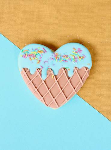 confectionery pink and blue icing coated doughnut sweets