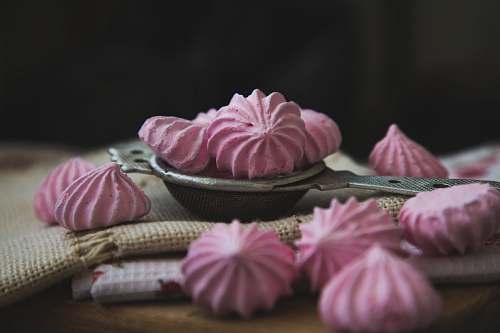confectionery pink meringues on white textile sweets