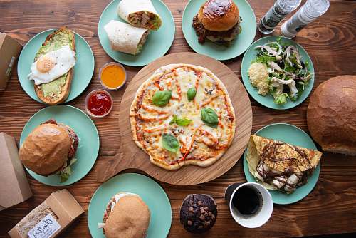 bread pizza between blue plates with taco, burger, and sandwich pizza