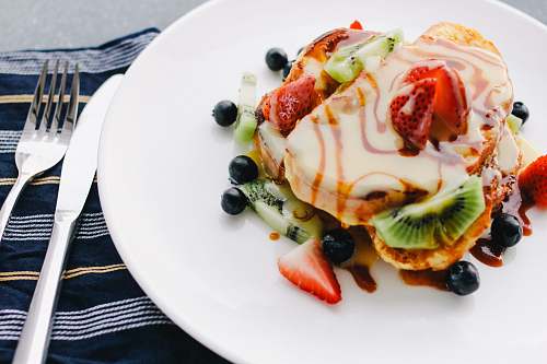 dessert plate of pancake with strawberry and kiwi toppings breakfast