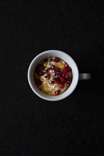 breakfast pomegranate seeds and cereals in mug oatmeal
