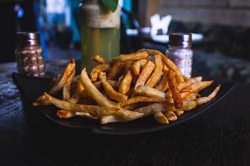fries potato fries on black ceramic plate on top of wooden table marrakesh