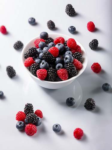 plant red and black raspberries on bowl blueberry