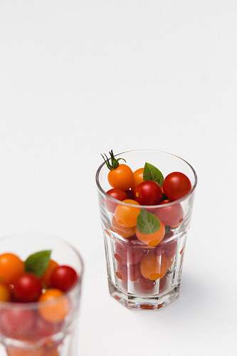 vegetable red and orange fruits in clear rock glass tomato