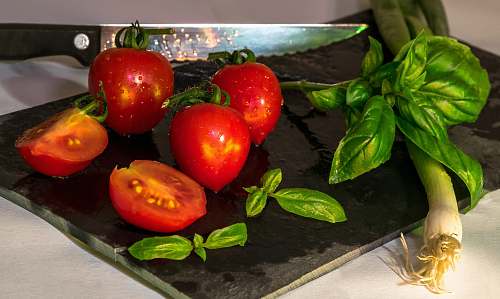 vegetable red tomatoes on black plate veggies