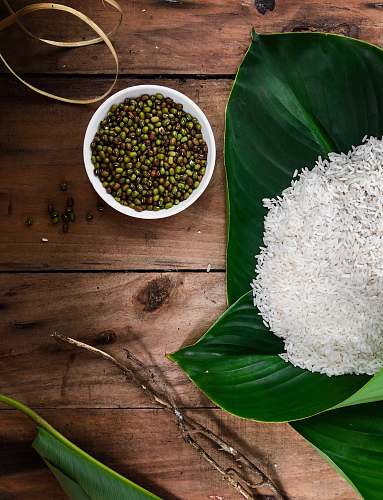 plant rice in green leaf beside bowl of seeds vegetable