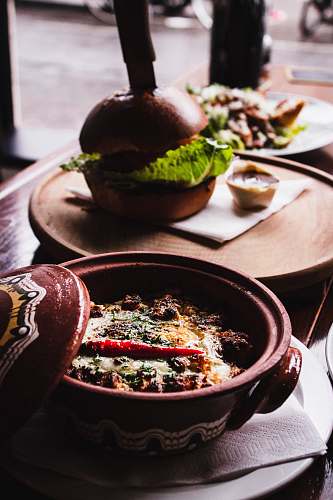 burger round brown ceramic bowl on table with cooked food dish