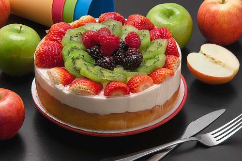 fruit round cake with assorted fruits on top apple
