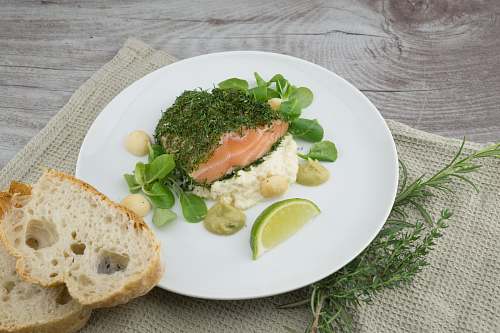 bread round white ceramic plate with lime on top plate