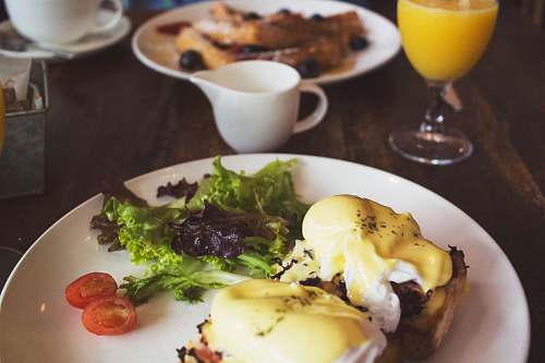 breakfast salad on white ceramic plate on table glass