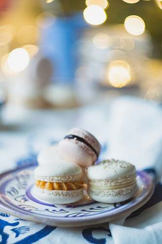 confectionery selective focus photo of macarons on purple plate sweets