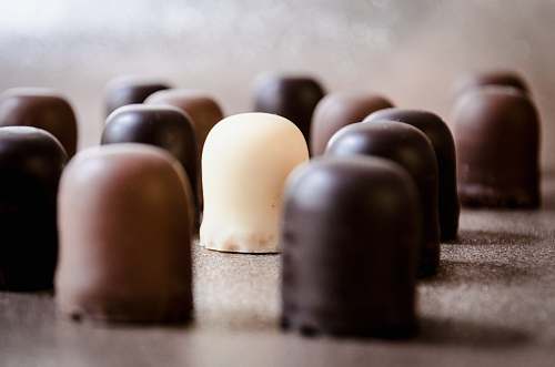 confectionery selective focus photo of milk chocolate surrounded by chocolate sweets