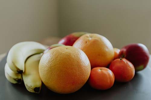 fruit selective focus photography of banana, orange, and apple fruits citrus fruit