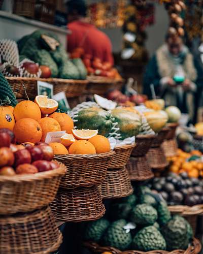 fruit selective focus photography of displayed basket of fruits citrus fruit