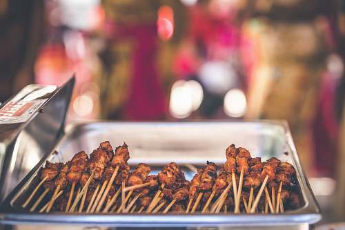 bbq selective focus photography of skewered pork on tray bali