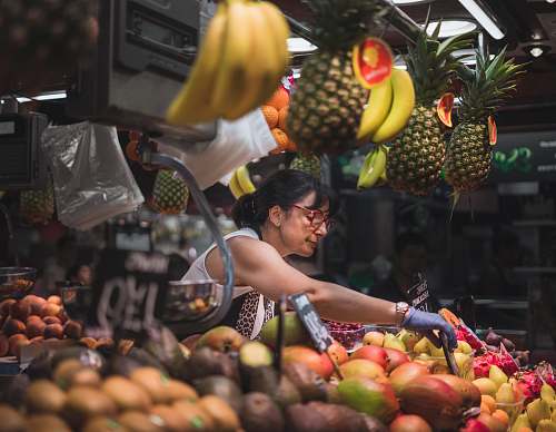 fruit selective focus photography of woman selling fruits flora