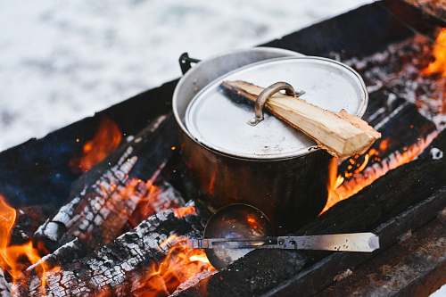 bbq silver cook pot on firewood outdoor