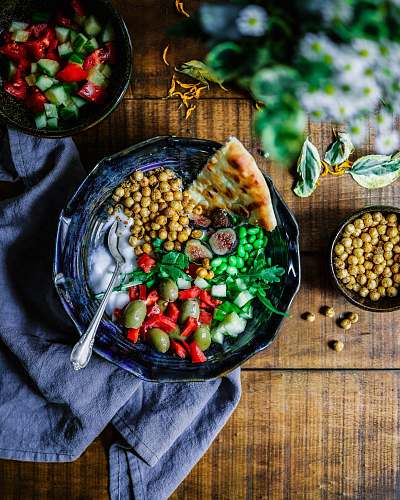 vegetable silver spoon on black ceramic bowl with vegetables plant
