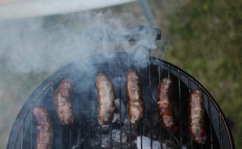 bbq six sausages on black charcoal grill sausages