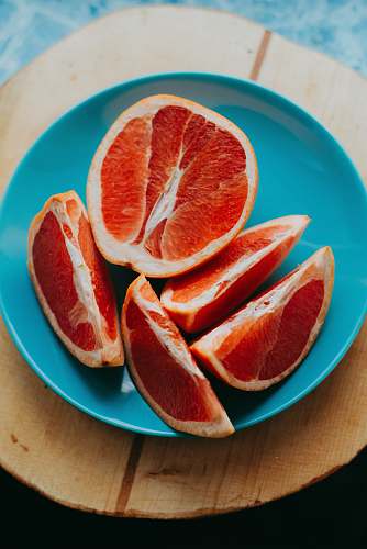 fruit slice fruits on blue plate grapefruit