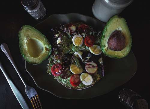 plant sliced avocado fruit and salad with eggs avocado