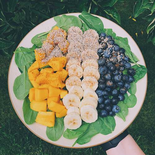 dish sliced blueberries, banana, and pineapple fruits in plate platter