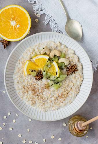 oatmeal sliced fruit and kiwi on plate flatlay