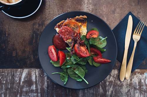 meal sliced tomato dish on black plate plate