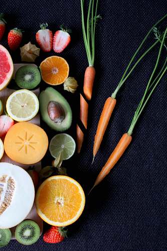produce sliced vegetable and fruits on board orange