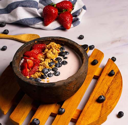 plant strawberries and black berries in brown bowl fruit