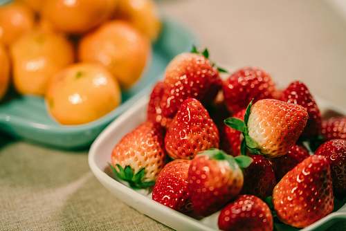 fruit strawberry and orange fruits in bowl plant