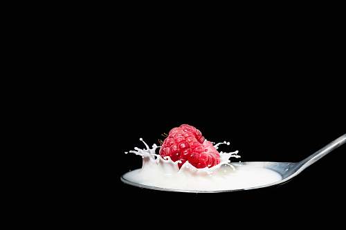 dessert strawberry fruit with milk on spoon creme