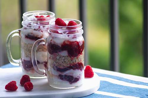raspberry strawberry ice cream in clear glass jars produce