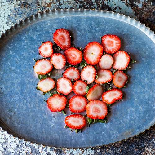 fruit strawberry slices on oval scalloped metal tray plant
