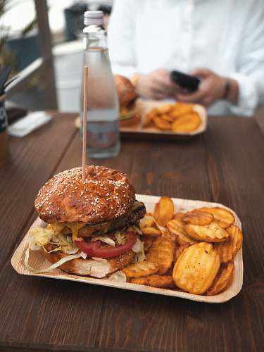 person tasty burger and potato fries on plate human