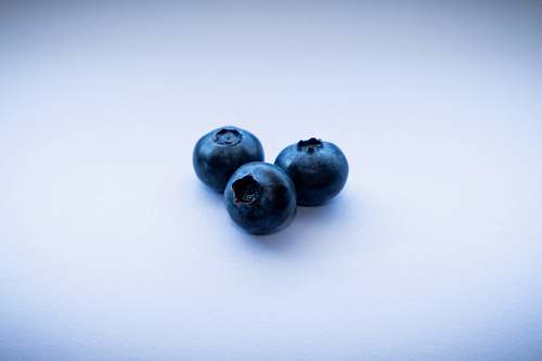 fruit three blackberries on white surface blueberry