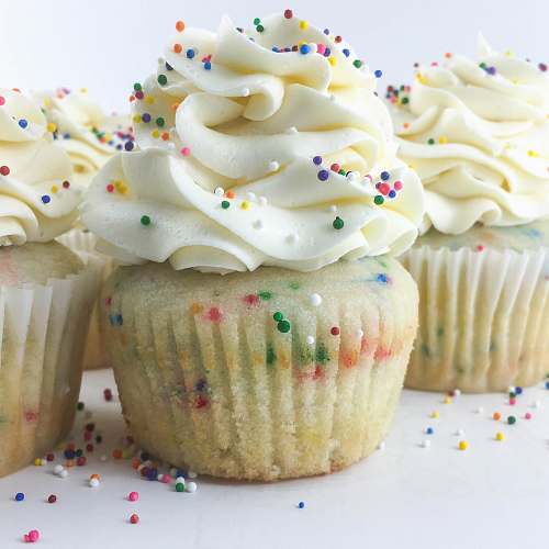 dessert three cupcakes with toppings cream