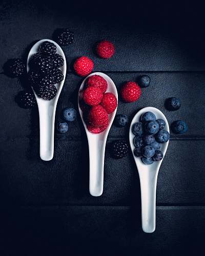 plant three ladles of berries on gray surface fruit