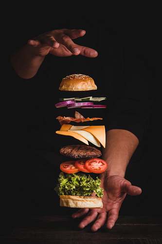 burger timelapse photo of man holding burger human