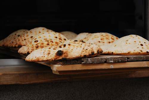 bread tray of food on wooden surface pita