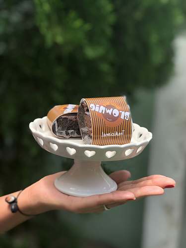 confectionery two brown cans and white cake stand sweets