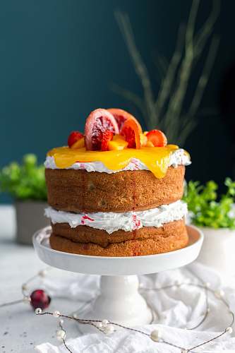 cake two-layered cake with citrus fruit and strawberry toppings dessert