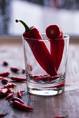 pepper two red chilies in clear shot glass vegetable