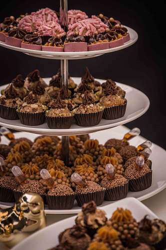 cake variety of cupcakes on cupcake rack cream