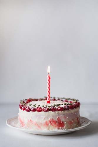 cake white and pink covered cake with lightened candle dessert