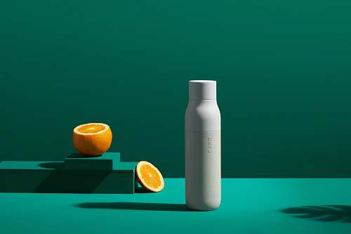 fruit white bottle near orange slice plant