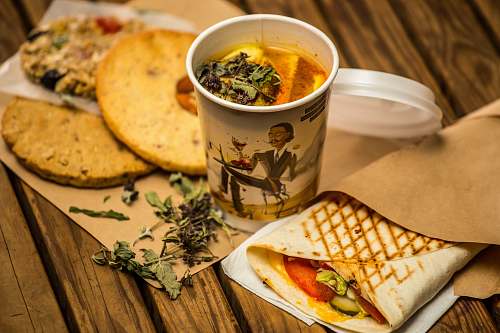 bread white cup besides bread in paper bowl