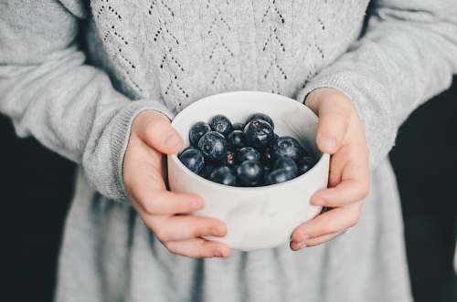 fruit woman carrying bowl of blueberries blueberry