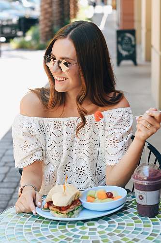 person woman eating fruits and sandwich human